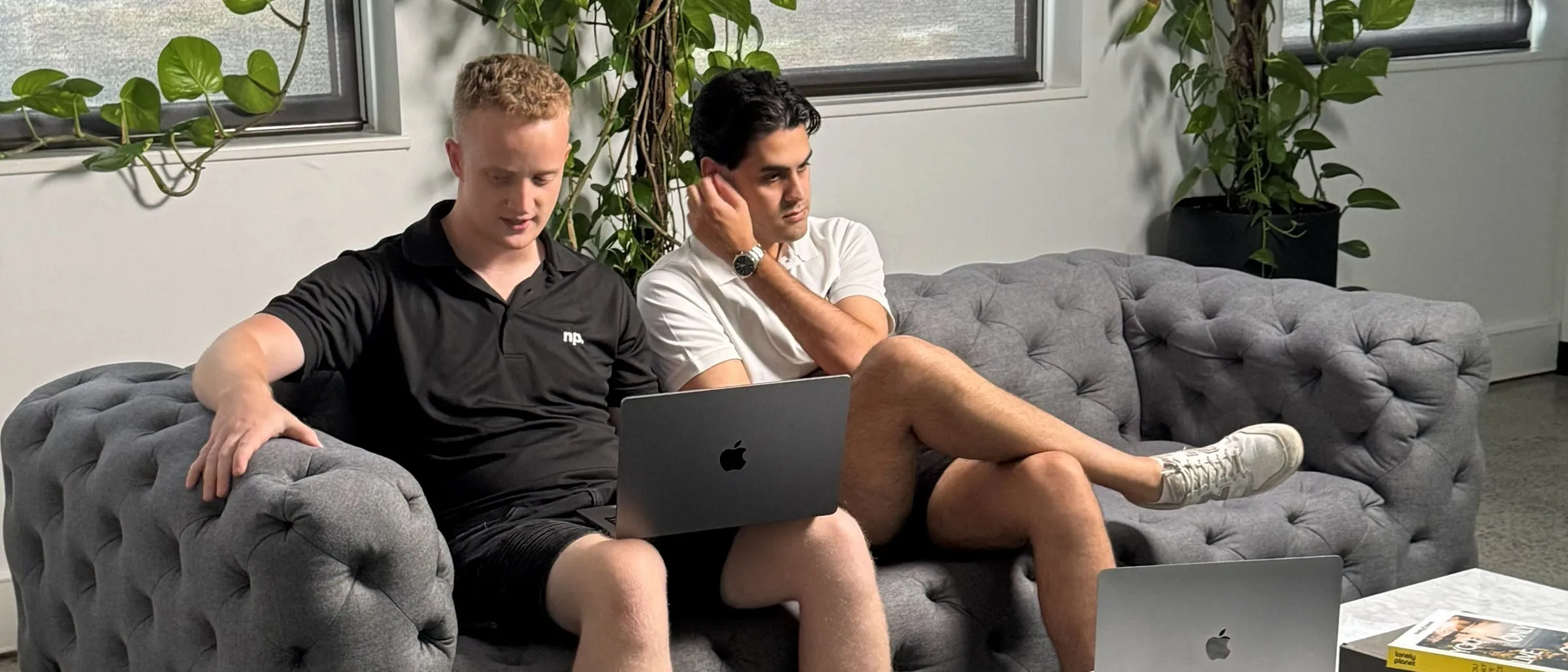 Two of the No Problem team working together on laptops
