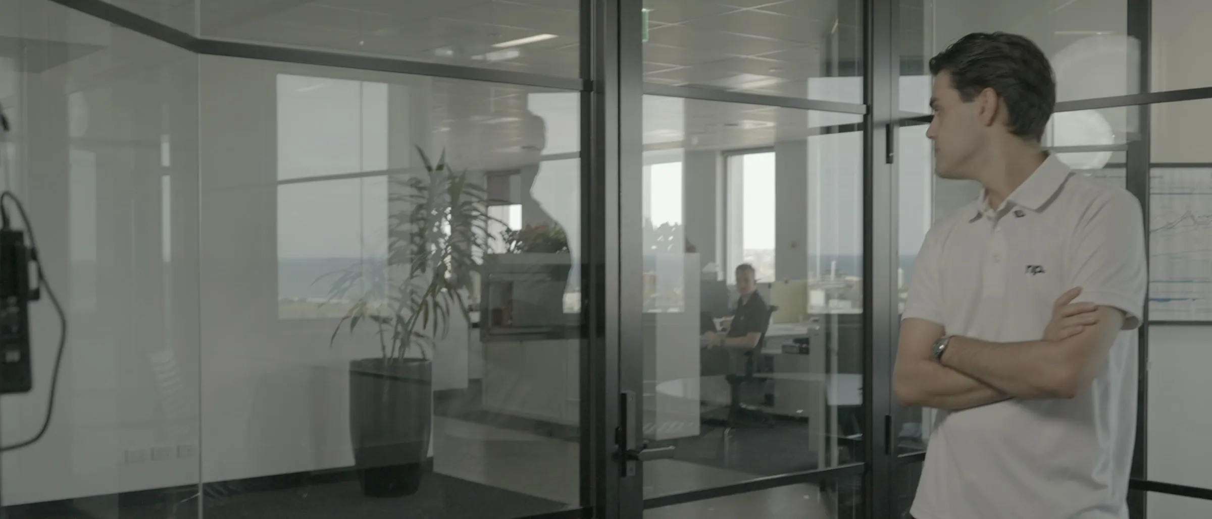 A No Problem team member in the office, with the team working behind the glass