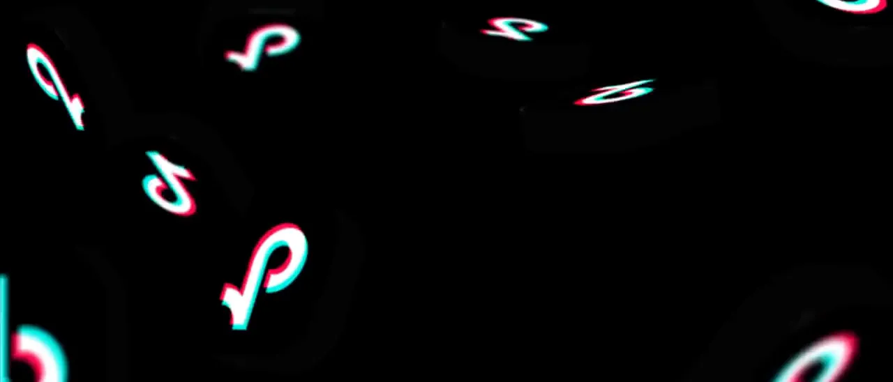 TikTok logos tumbling across a black background
